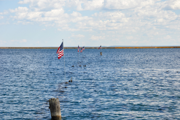 buoys in the water that also carry the USA Flag