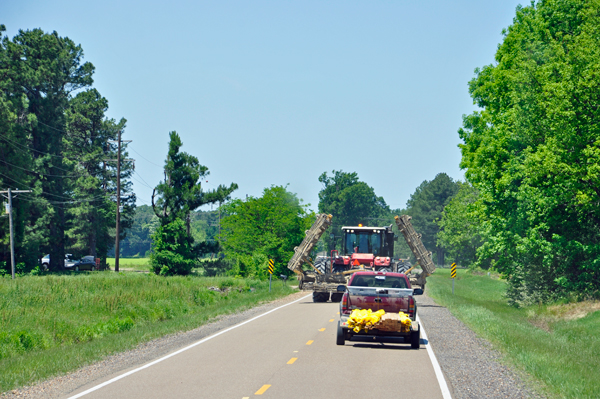 a farm machine taking up the entire road