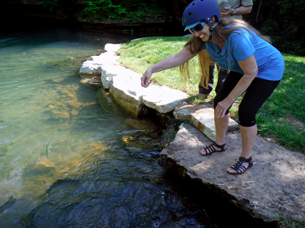 Karen Duquette feeding the rainbow trout