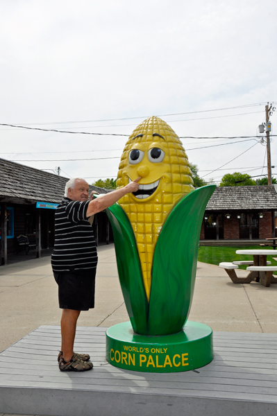 Lee Duquette pinching himself a nose of corn