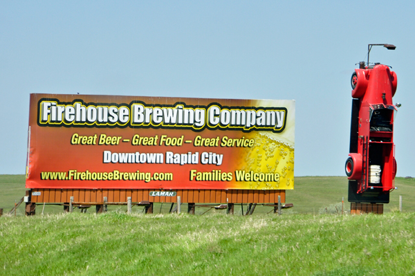 Firehouse Brewing Company sign and firetruck upside down