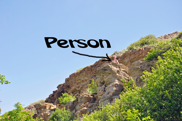 person trying to climb down the cliff