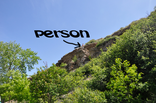 person trying to climb down the cliff