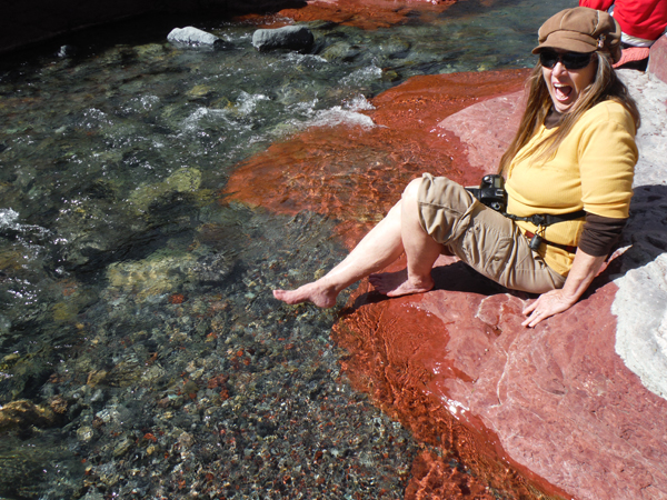 Karen Duquette sticks her foot in icy water