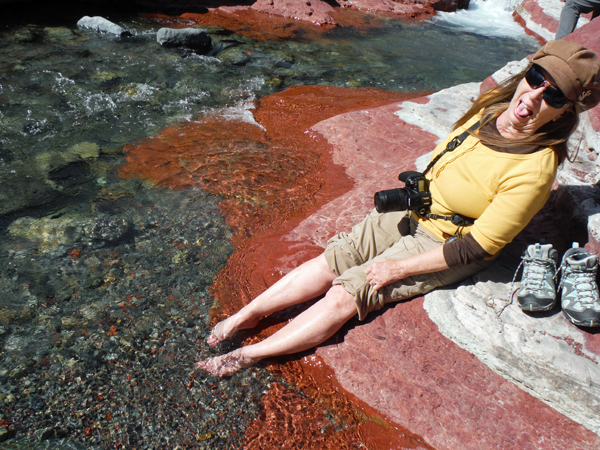 Karen Duquette sticks her feet in icy water