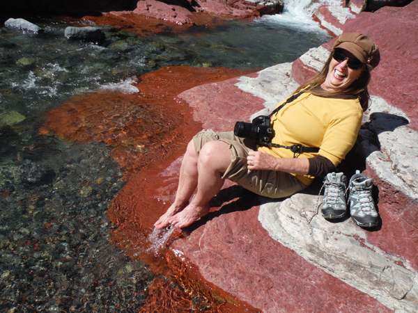 Karen quickly pulls her feet out of the icy water
