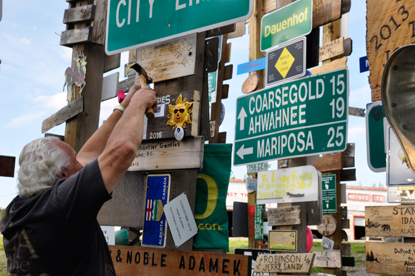 Lee Duquete posting a sign