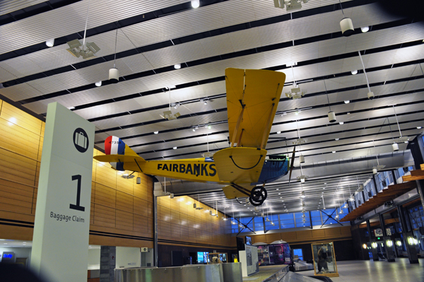 airplane hanging from ceiling at airport