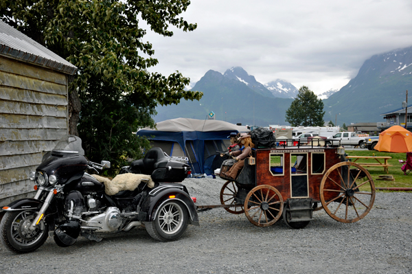 motorcyle pulling a stagecoach and dolls