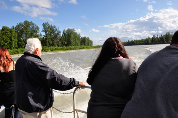 standing at the stern of the boat