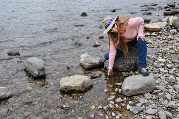 Karen Duquette feeling the water at Lake McDonald