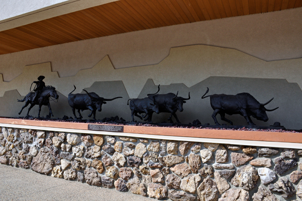 statues on the outside of the Cowboy Hall of Fame