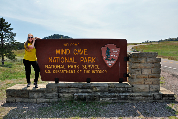 Karen Duquette at the Wind Cave National Park sign