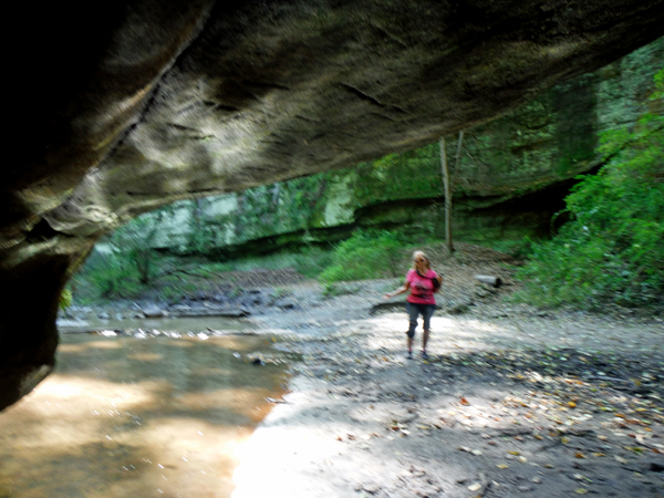 Karen Duquette under the ledge of a cliff