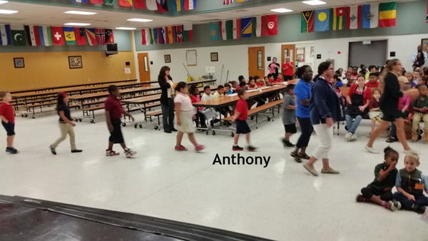 Anthony and other children marching in