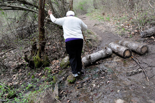 Lee Duquette hiking around the water and mud