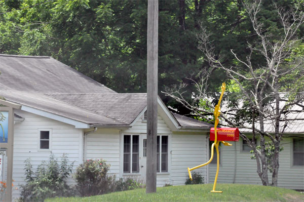 A yellow walking man mailbox