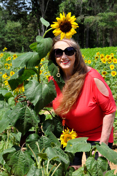 Karen Duquette in a field of sunflowers