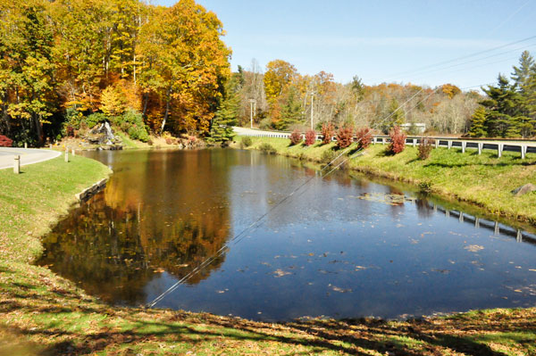 A small waterfall by the roadside pond at Linville Land Harbor