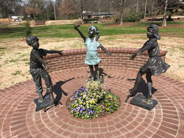 dancing children statues