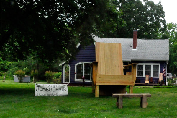 a big chair in front of a house