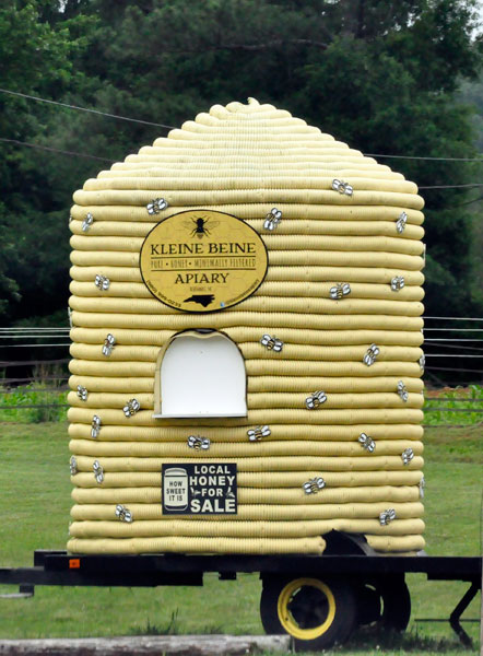 a giant honey hive in front of a store