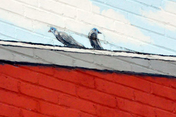 birds on the roof of the mural