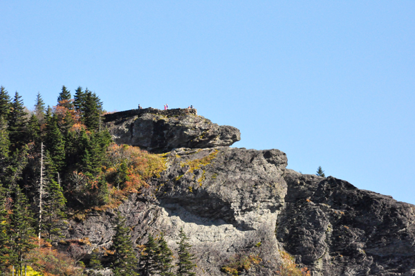 people way up on a big rock