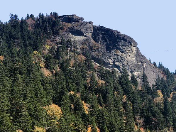 people way up on a big rock