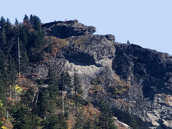 people way up on a big rock