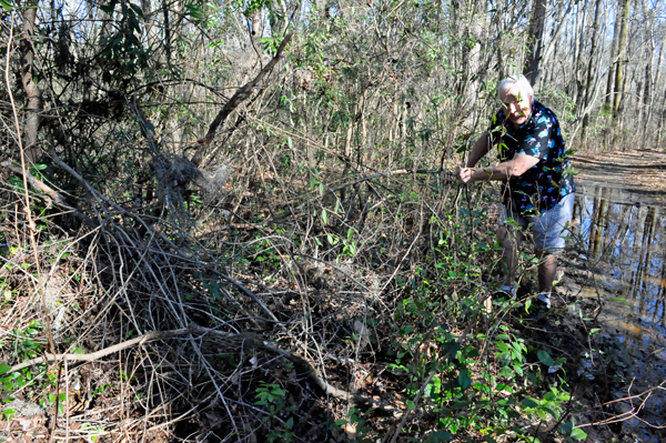 Lee Duquette trying to maneuver around the flooded hiking trail