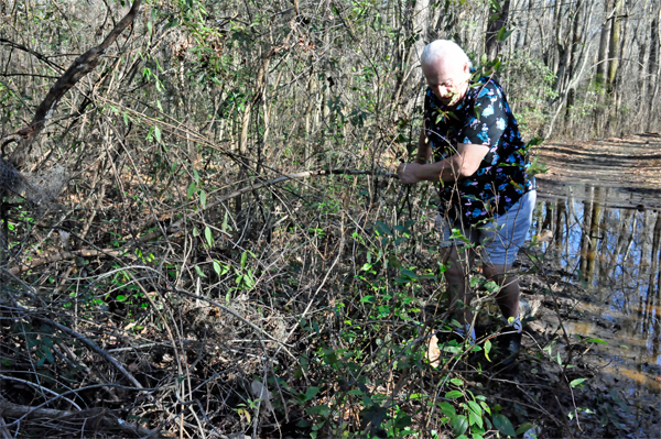 Lee Duquette trying to maneuver around the flooded hiking trail