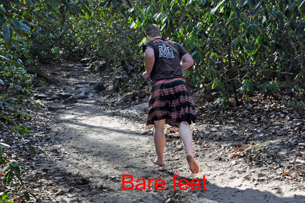 a barefoot man in a kilt