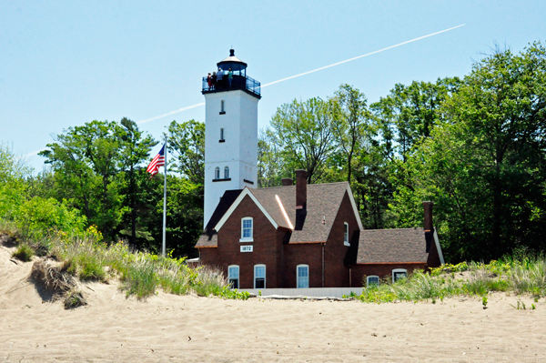 Presque Isle Lighthouse and the U.S.A. Flag as seen from the beach