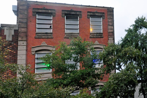 building with colored lights in some of its windows.