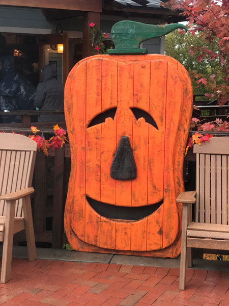 a big flat wooden pumpkin