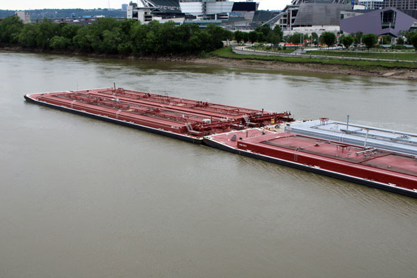 barge emerging out from under the bridge