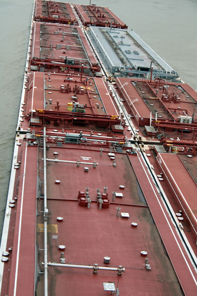 barge emerging out from under the bridge