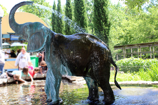 fake elephant blowing water out of its trunk