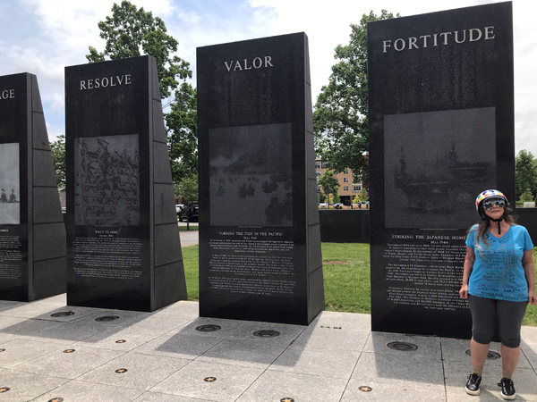 vertical pylonswith engraved images from war time and Karen Duquette