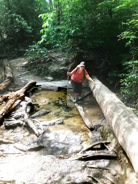 Karen Duquette making her way across a creek crossing