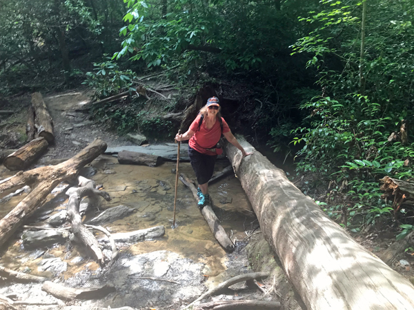 Karen Duquette making her way across a creek crossing