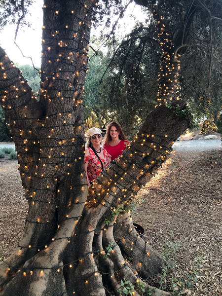 Karen and Ilse by a lit tree