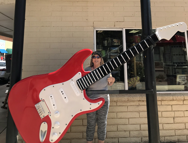 Karen Duquette and a big red guitar