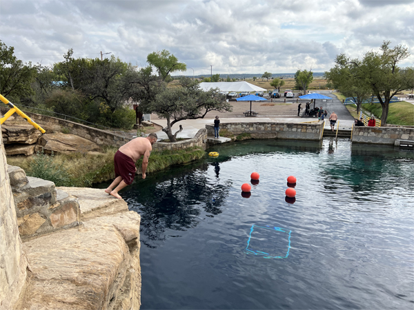 someone diving from the big rock 