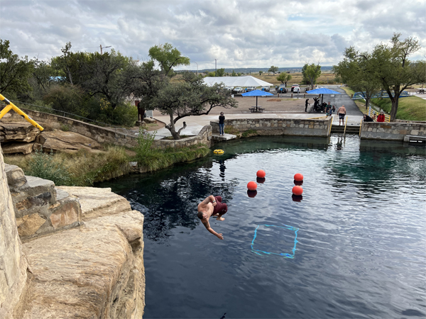 someone diving from the big rock 