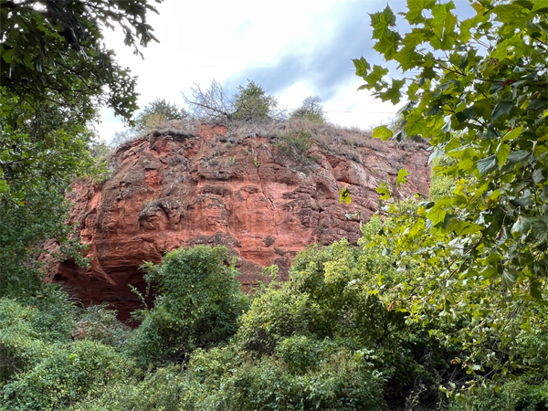 big red rock behind the RV