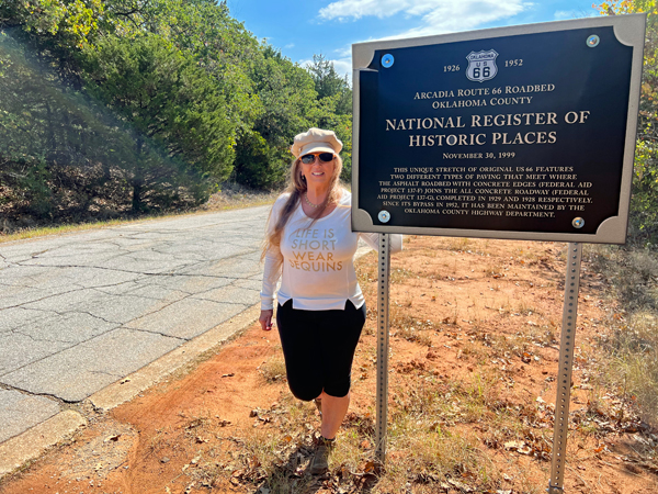 Karen Duquette at the National Register of Histori Places sign