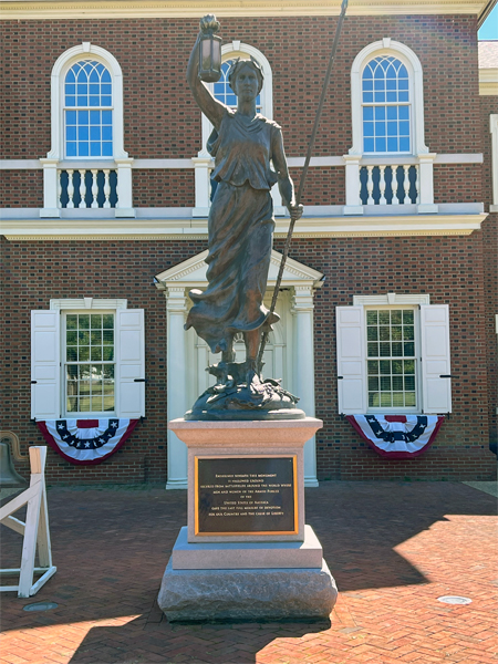 American Village building and statue