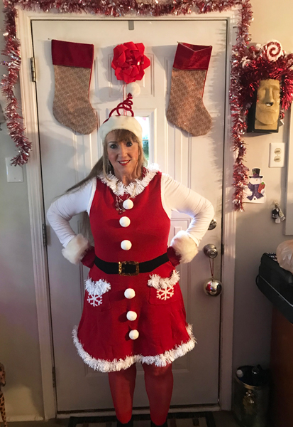 Karen Duquette in a Christmas outfit and hat